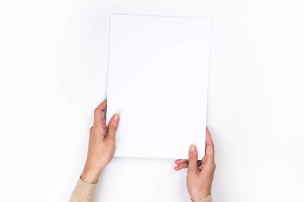 istock Woman's hands with perfect manicure holding  notepad as mockup for your design. White background, flat lay 1162814025