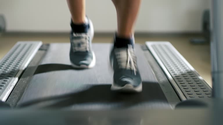 SLO MO CU Man running on a treadmill