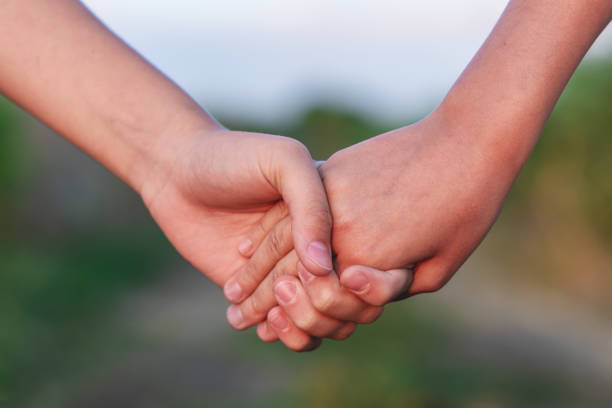 istock young unrecognizable lesbian couple holding hands at sunset outdoors. Lifestyle and pride concept. 1162814204