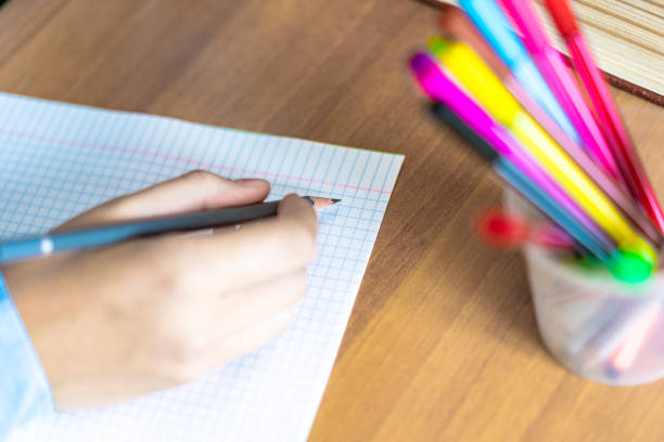 istock schoolgirl doing homework with pencil on paper, back to school comcept 1162814335