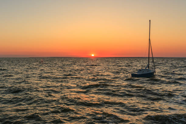 boat on the sea with the sun setting