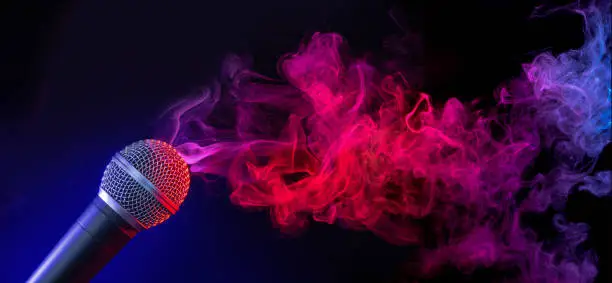 Photo of mic in a smoky stage