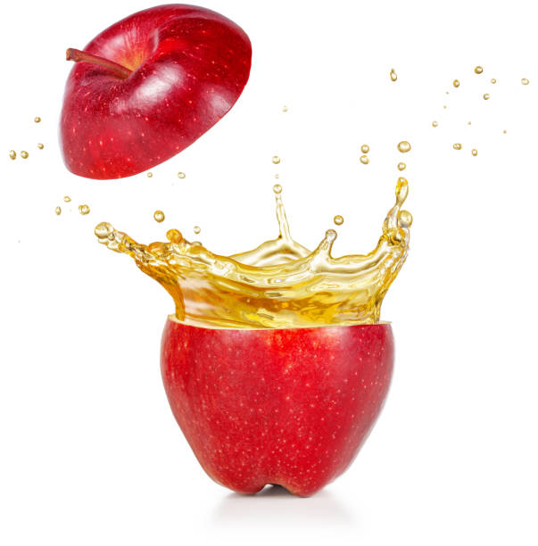 juice spraying out of a red apple