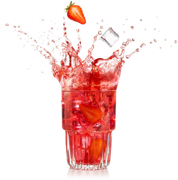 strawberry cocktail glass splashing on white background strawberry and ice cube falling into a splashing cocktail isolated on white red drink stock pictures, royalty-free photos & images