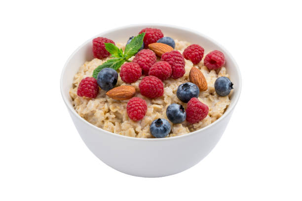 istock Oatmeal with raspberries, almonds and blueberries and mint isolated on white 1162820724