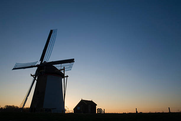 istock silhouetted windmill against a colorful sunset 116282165
