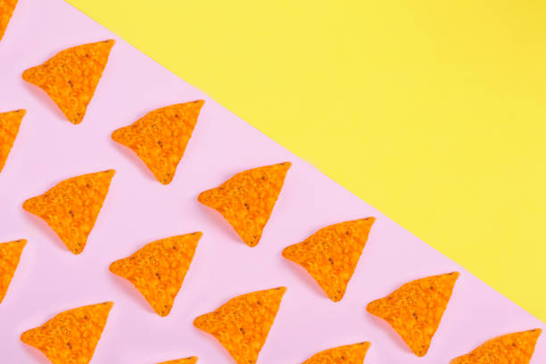 istock Potato chips pattern on pastel yellow and pink background 1162822039