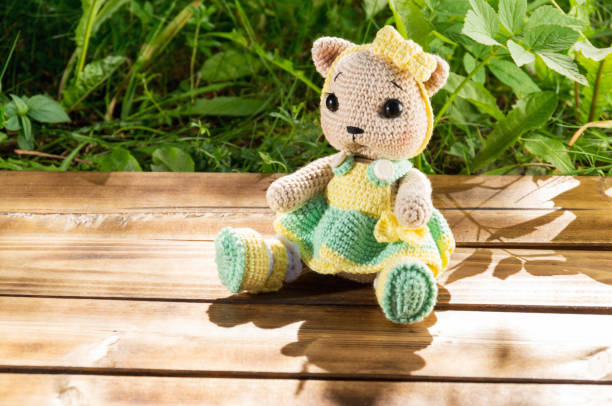 istock Hand made knitted toy on wood background 1162822167