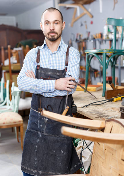 istock Craftsman in furniture restoration workshop 1162822402