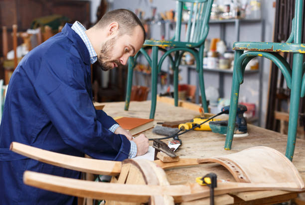 istock Carpenter repairing antique chair 1162822405