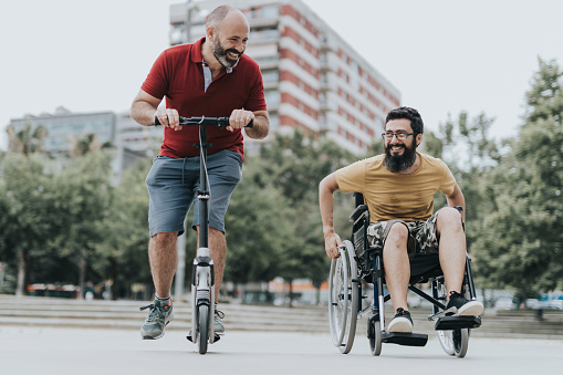 Disabled Happy friends having fun together outside.