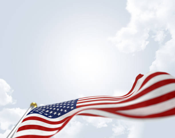 American flag on sky background blowing in the wind