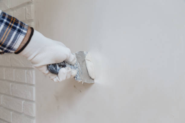 istock Putty the wall gypsum putty with spatulas. 1162823681