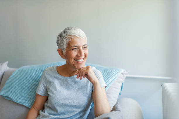 istock Beautiful middle age woman smiling at home 1162823759