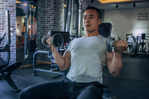 istock Muscular man exercising with dumbbell 1162827861