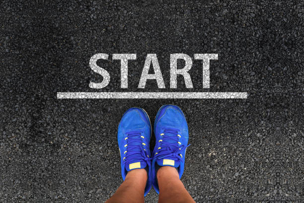 Start man with a shoes is standing next to line and word START starting line stock pictures, royalty-free photos & images