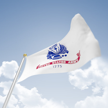 US Army Flag on blue sky background blowing in the wind