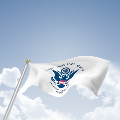 US Coast Guard Flag on blue sky background blowing in the wind