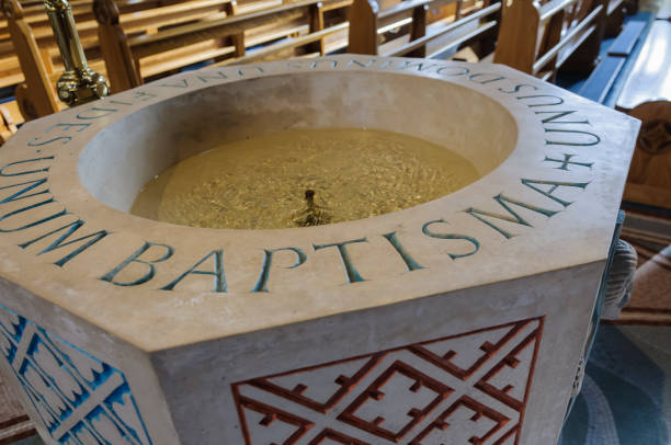 Baptismal font in a church Baptismal font in a church baptismal font stock pictures, royalty-free photos & images