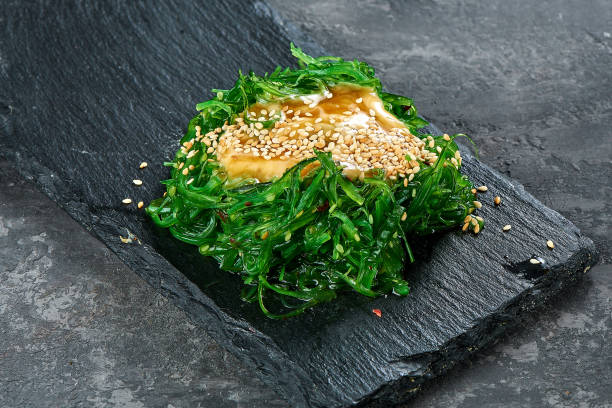 istock Seaweed salad in a black plate. Chuka wakame 1162840240
