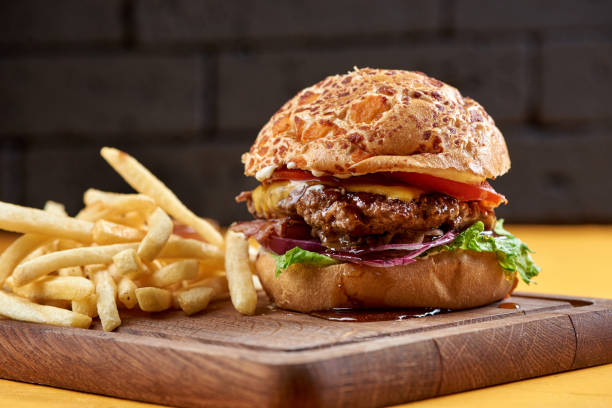 istock burger with onion rings, cheese and jack daniel's sauce 1162840318