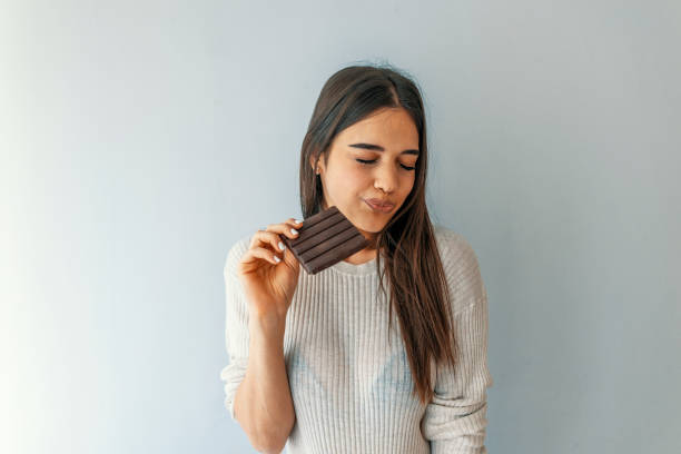 istock Girl tasting sweet chocolate. 1162841434
