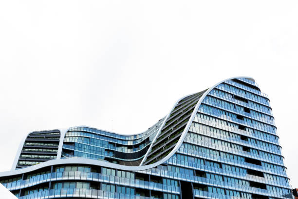 istock Low angle view of modern apartment building, white background with copy space 1162841439