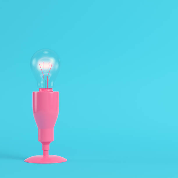 istock Pink lamp with glowing light bulb on bright blue background in pastel colors 1162842917