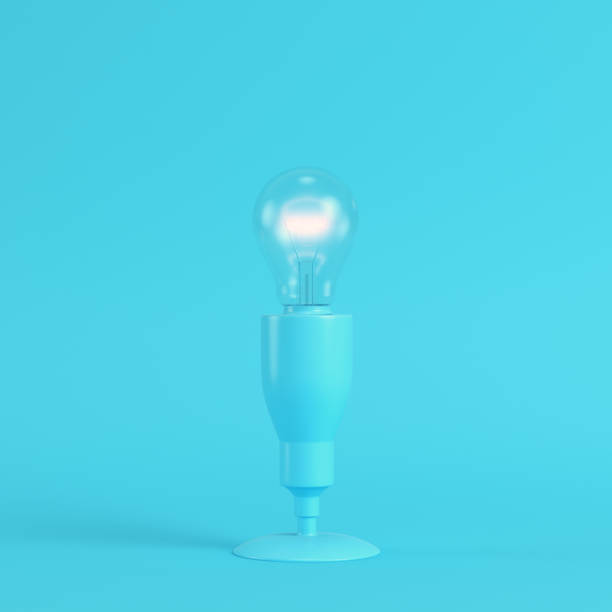 istock Lamp with glowing light bulb on bright blue background in pastel colors 1162843554