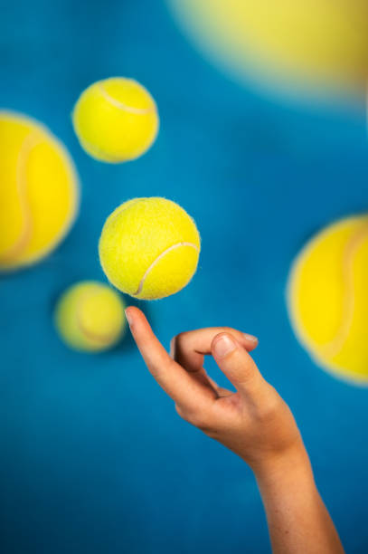 istock Flying tennis balls on blue background 1162845645