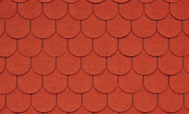 istock Close up view on red asphalt roofing shingles background. 1162847787