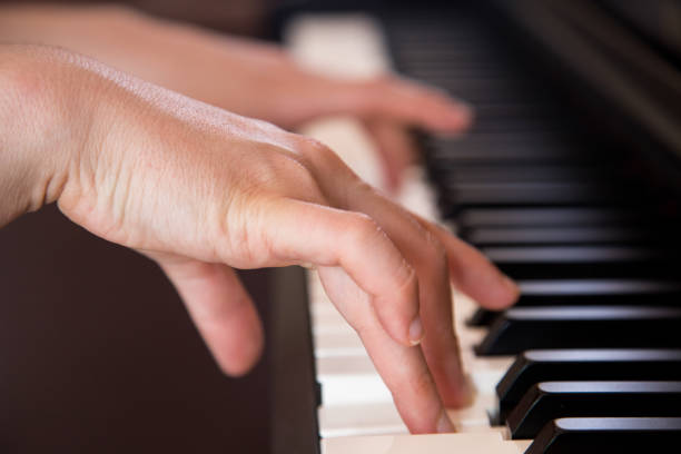 istock woman hand playing the piano 1162849396