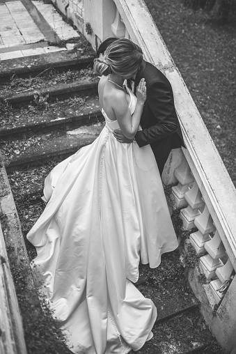 side view of romantic wedding couple kissing, affection, love and emotion feelings.black and white shot.
