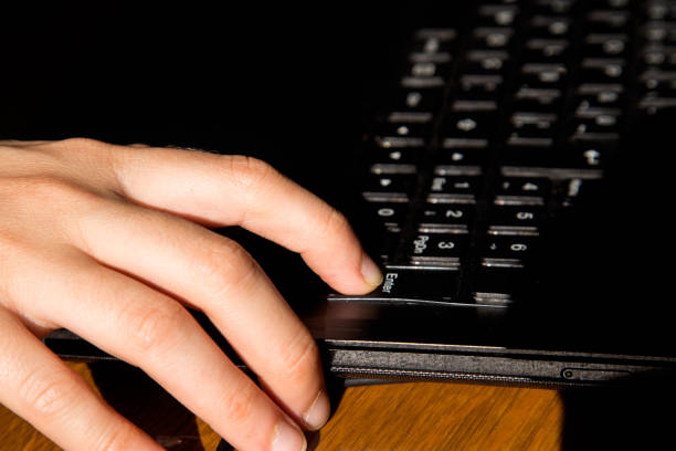 istock Closeup of a hand about to press on a keyboard 1162850570