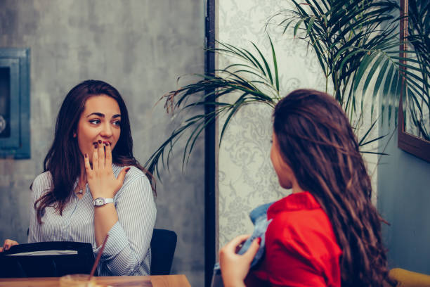 istock Two beautiful girl sharing their new purchases with each other 1162852413