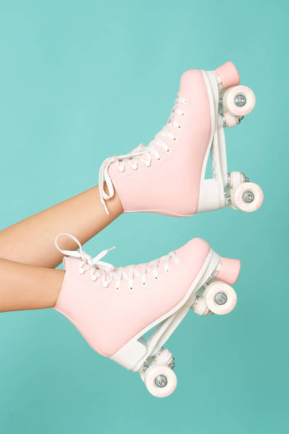 istock Pink roller skates on the legs. Activity can be fun! 1162853614