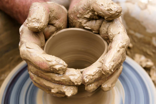 istock male hands making a mug on a potter's wheel 1162854573