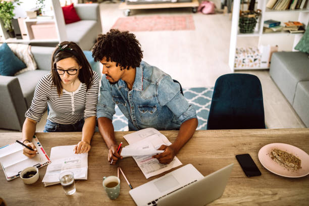 istock Multi-ethnic couple planning their home budget 1162855471