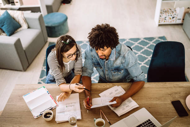 Multi-ethnic couple planning their home budget