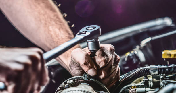 istock Auto mechanic working on car engine in mechanics garage. Repair service. authentic close-up shot 1162856876