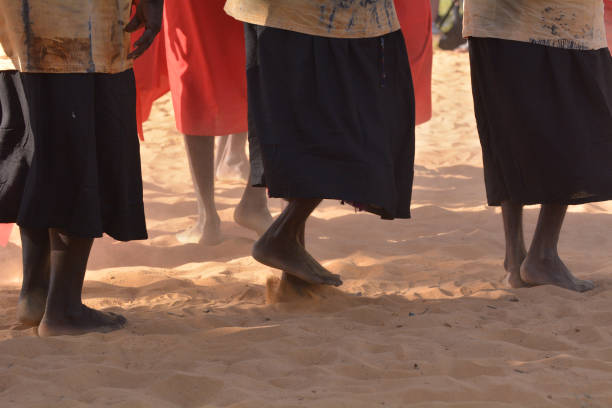 Indigenous Australians aboriginal women dancing a cultural ceremony dance Unrecognizable group of Indigenous Australians aboriginal women dancing a cultural ceremony dance. aborigine woman stock pictures, royalty-free photos & images