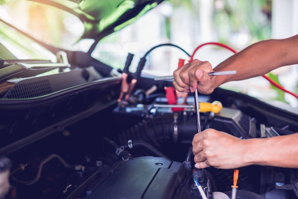 istock Car mechanic is holding a wrench ready to check the engine and maintenance with blurry voltmeter for check voltage level in battery. 1162858311