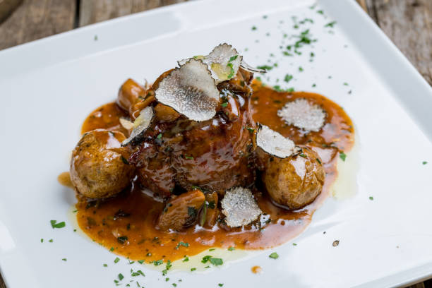istock filet Mignon with truffle on white plate on wooden background 1162859721