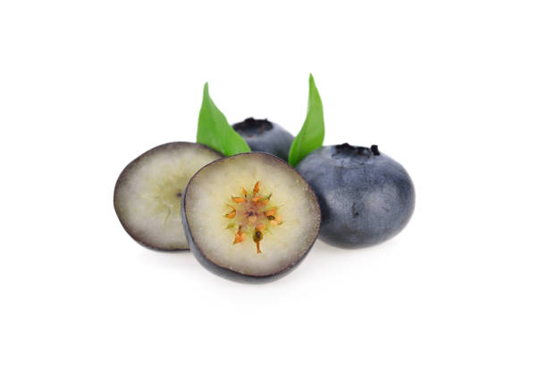 whole and half cut fresh blueberries on white background