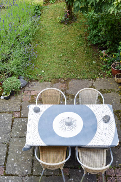 istock Rustic style garden patio area with table and chairs for outdoors eating area 1162862936