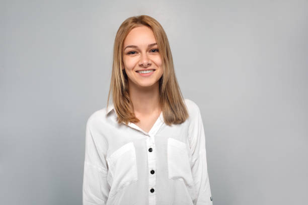 istock Young woman standing isolated on grey smiling cheerful 1162865314