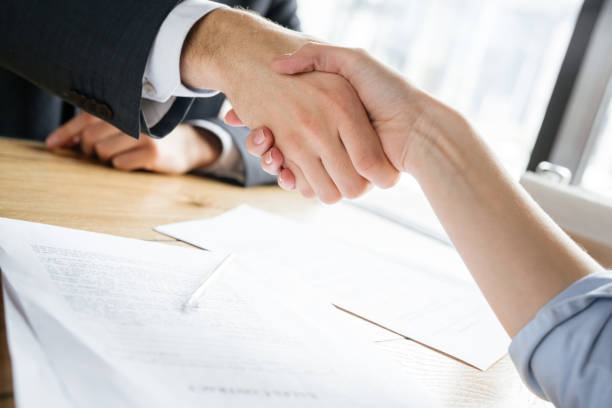 istock Businesspeople having business lunch at restaurant sitting shaking hands 1162865355