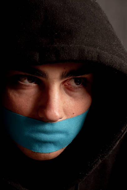 istock Young man expresses how he feels..silenced! by using tape across his mouth. 1162866282