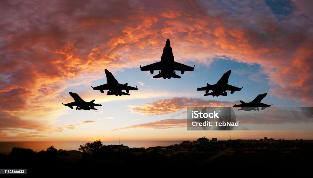Five airplanes Five fighters flying at sunset Fighter Plane Stock Photo