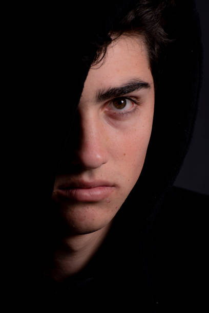 istock Swarthy young man in hoodie looks at camera. 1162867456